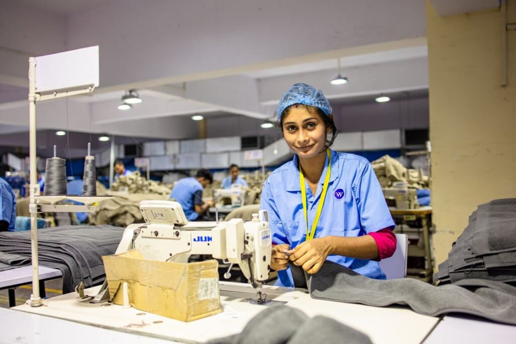 Female textile worker using a sewing machine in a garment factory